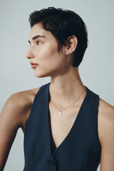 Profile view of a model showcasing the Temple of the Sun Soma Coin Necklace in Sterling Silver.