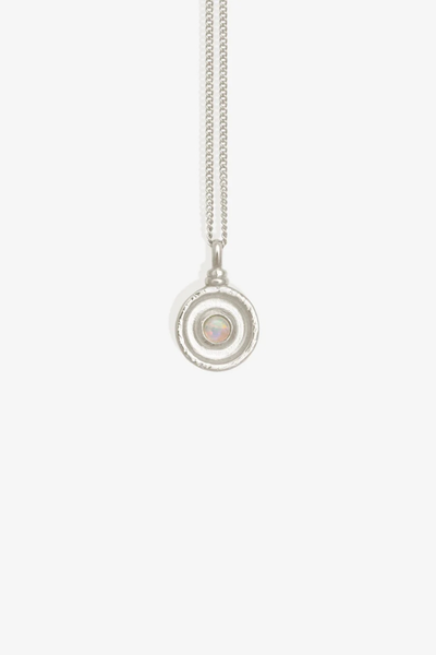 Studio product shot of the Temple of the Sun Soma Coin Necklace in Sterling Silver featuring a round Australian opal set in a concentric textured coin pendant.