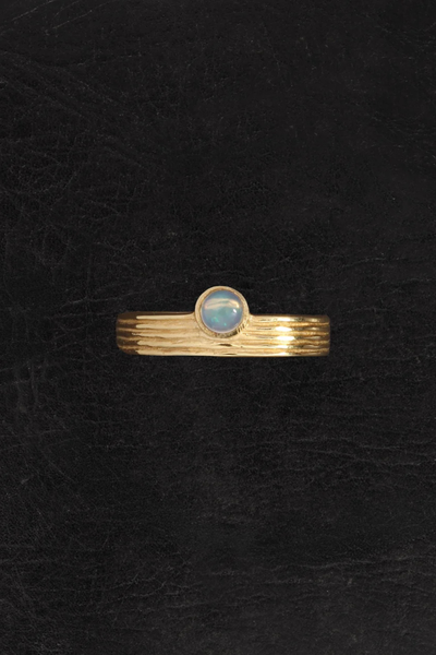 Top-down product shot of the Temple of the Sun Soma Ring in 18k Gold Vermeil displaying the iridescence of the opal gemstone on a dark textured background.