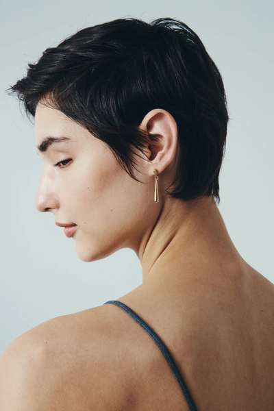 Profile photo highlighting the fluid raindrop silhouette of the Stilla Earring in 18k Gold Vermeil on a model.