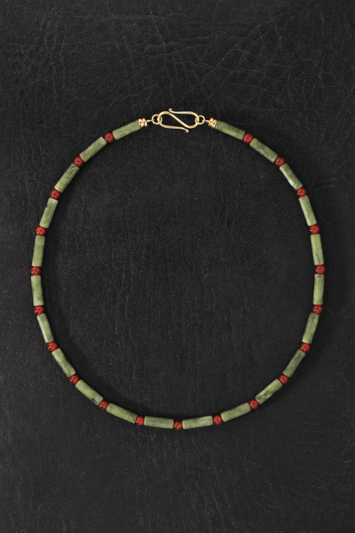 Overhead product photo of the Temple of the Sun Vana Beaded Necklace laid out in a circle on a dark textured background.