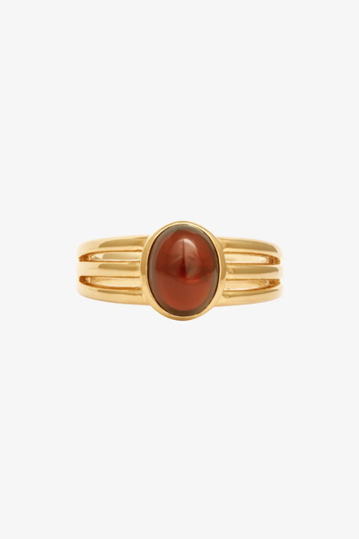 Isolated studio shot of the Temple of the Sun Vega Ring in 18k Gold Vermeil with an oval garnet cabochon.