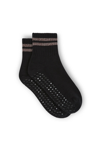 Studio flat lay of the pair of black midi-ankle grip socks, showing the twin bronze metallic stripes around the ribbed cuffs and the black non-slip grippers covering the soles.