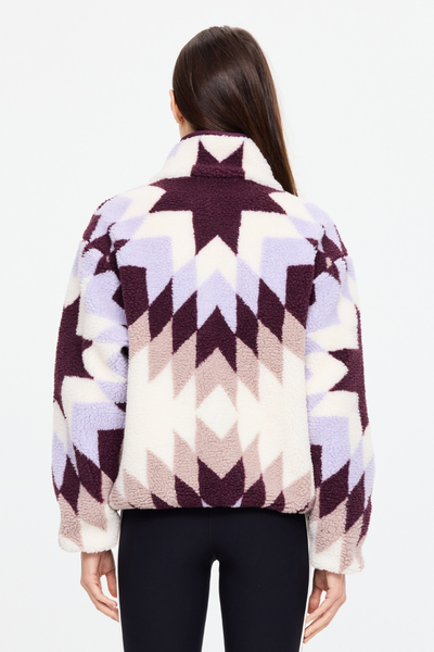 Rear view of the relaxed-fit Harlow Fleece Pullover in Maple Chaud by The Upside, highlighting the back geometric star pattern and high collar.
