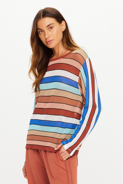 Studio front portrait of model Eden wearing the relaxed-fit Iza Milla Long Sleeve Knit Top with a ribbed crew neckline and multicoloured stripes by The Upside.