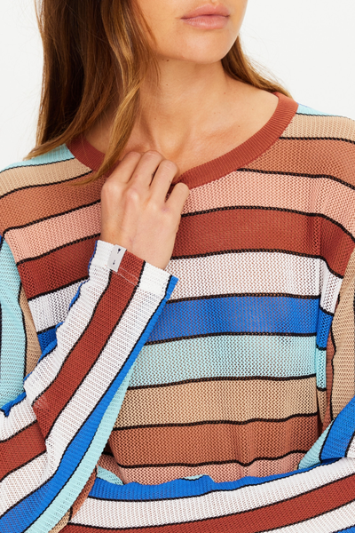 Studio front portrait of model Eden wearing the relaxed-fit Iza Milla Long Sleeve Knit Top with a ribbed crew neckline and multicoloured stripes by The Upside.