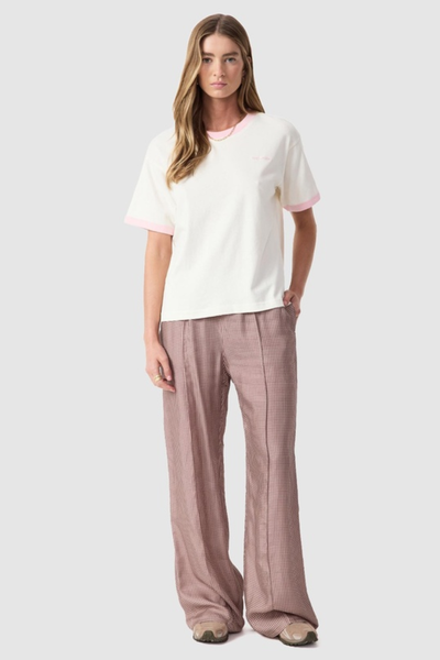 Studio full-length front view of a model wearing the relaxed-fit quartz tee, patterned wide-leg trousers, and sneakers.