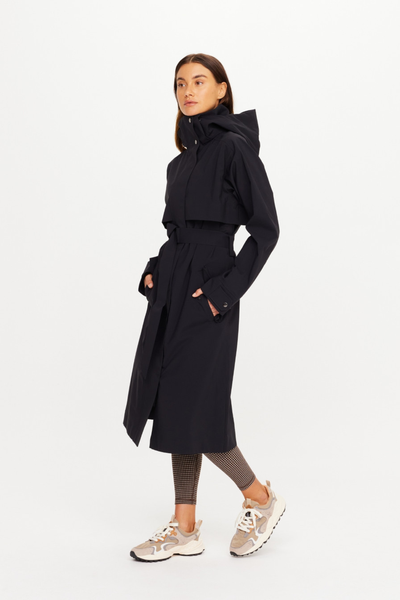 Side profile studio shot of the closed, belted James Hooded Trench Coat in black sand. The image demonstrates the sleek drape of the waterproof, recycled polyester fabrication, highlighting the sleeve cuff snap-placket detail and the streamlined utility design.