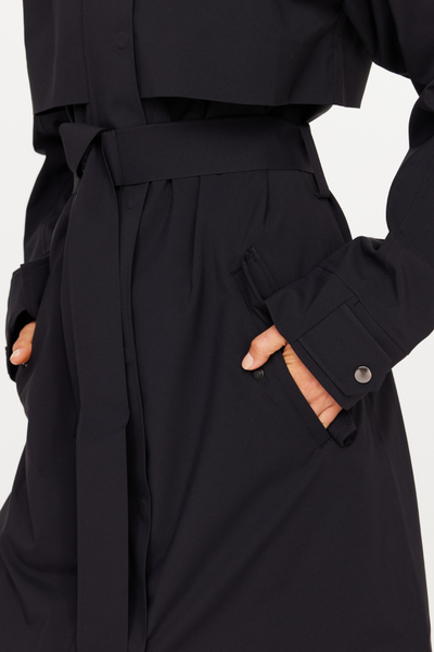 A detailed close-up shot of the James Hooded Trench Coat waist and sleeve. The image highlights the thick fabric tie belt, a front hip pocket featuring a protective snap flap closure, and a sleeve cuff detailed with an adjustable snap placket.