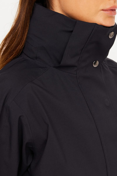 Close-up studio shot of the high stand collar on the James Hooded Trench Coat in black sand. The image shows the structured neck panel, precise stitching, and gunmetal-toned metal snap closures designed to block out cold winds and rain.