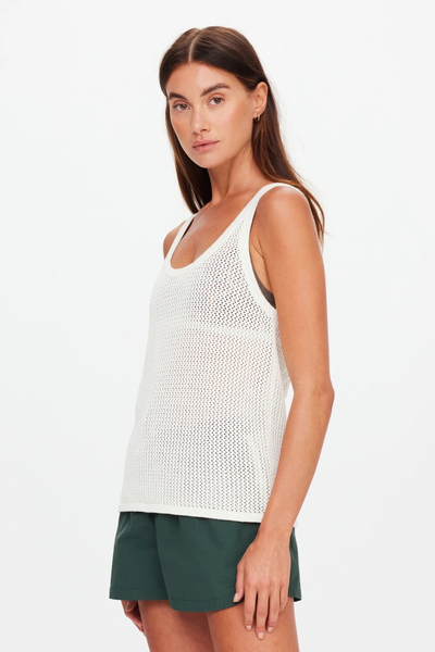 Side profile view of a model wearing the relaxed-fit open-knit tank top and green shorts against a white background.