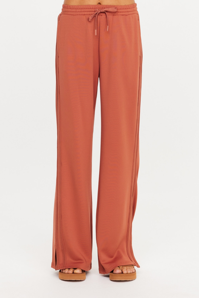 Front shot from the waist down showing the elasticated waistband with drawcord on The Upside Roma Pant in Desert Rose.