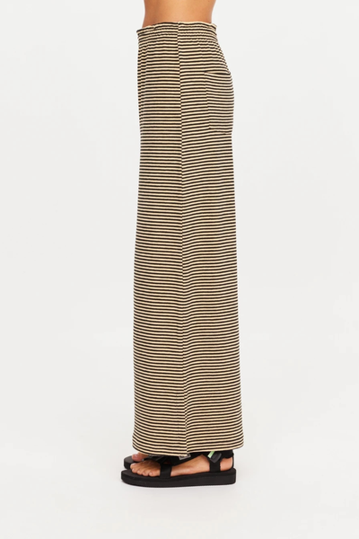 Side profile view highlighting the clean drape and side hem split of the pant.