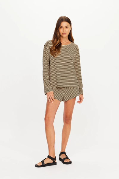 Full-body front studio shot of a model wearing the striped top, matching shorts, and black sandals.