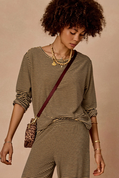 Close-up studio portrait of a model wearing the striped Santos Rio Long Sleeve Top and matching pants.