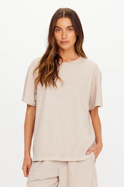 Front studio portrait of a model wearing The Upside Soho Sammi Tee in Mushroom paired with matching lounge pants.
