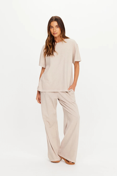 Full-body studio view of a model wearing the oversized mushroom tee and matching wide-leg pants.