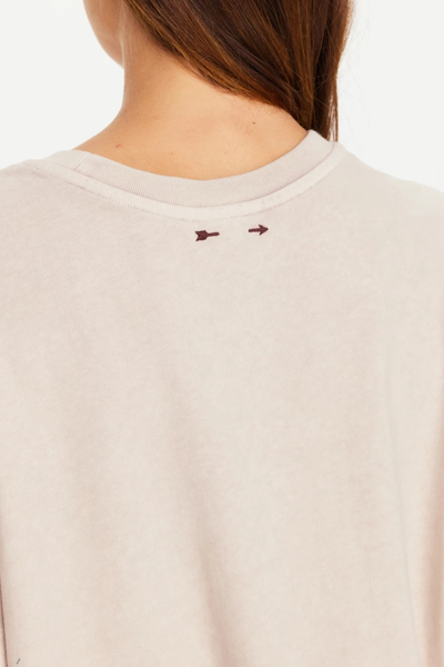 Close-up rear view of the ribbed neckline featuring the signature embroidered plum arrow logo.