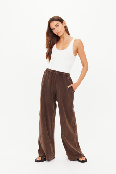 A full-length studio shot from the back showing the dark brown Soho Tokio Wide Leg Pant on a model, highlighting the high-waisted fit, relaxed pool over the heels, and clean rear silhouette.