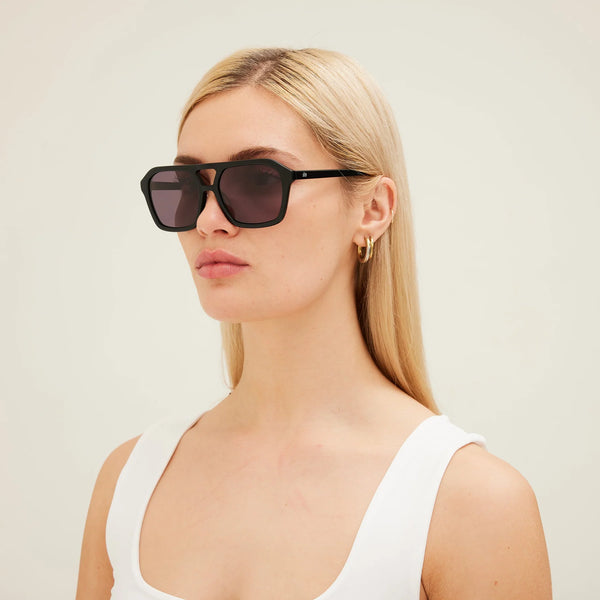 A three-quarter studio product layout of "The Void" sunglasses in tortoise shell, angled sharply to the right. This perspective highlights the face-framing thickness of the handcrafted acetate frame, the integrated molded nose pads, the streamlined temple arms, and a small gold-toned "SITO" logo plaque inlaid near the temple hinge.