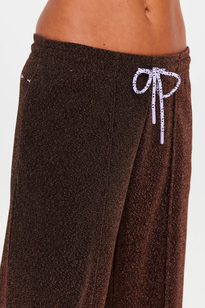 Close-up studio view focusing on the elasticated waistband and purple paracord drawcord of the chocolate metallic pants.