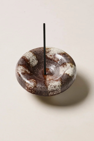 Studio product shot of the Gentle Habits Vessel Incense Holder in Chocolate with a black incense stick inserted vertically into the center opening on a neutral background.