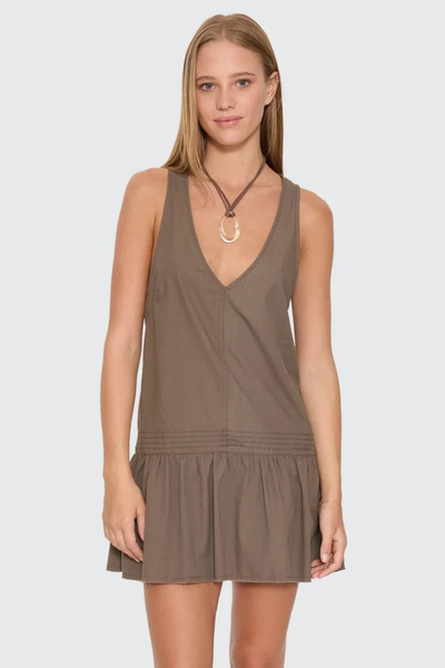 Front portrait of a model wearing the relaxed-fit Thrills Avery Mini Dress in Olive, styled with a statement cord pendant necklace.