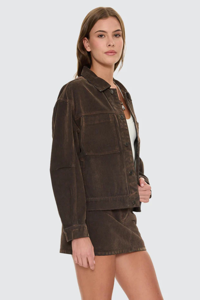 A full back view of the dark chocolate street jacket on a model, showcasing the clean vertical panel construction and the matte, velvety depth of the viscose flocking across the shoulders.