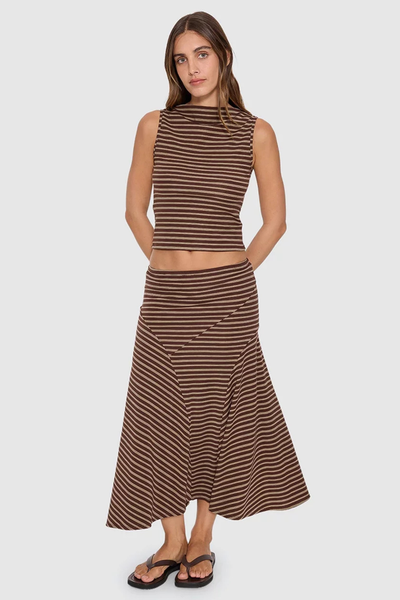 Full-length front studio shot of model wearing the Thrills Best of Luck Sienna Midi Skirt in Cocoa set with a matching striped high-neck tank top and flip-flops.