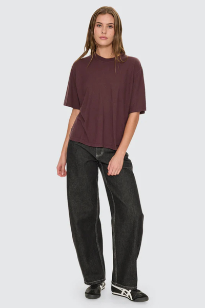 A full-length front studio shot of a model wearing the Thrills Hemp Square Tee in Aubergine, showcasing the wide square fit, relaxed crew neckline, and rich plum-purple hue.