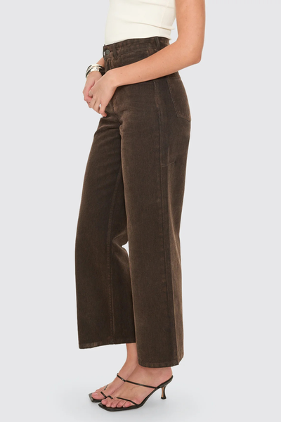 A rear-angle studio shot focusing on the high-rise waistband construction, rear belt loops, and tonal accent stitching.