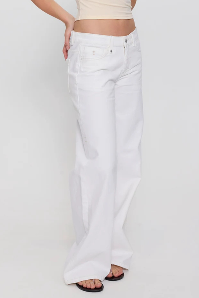 Studio three-quarter front view focusing on the waist and hip silhouette of bright white low-rise wide-leg jeans with gold palm tree embroidery on the coin pocket.