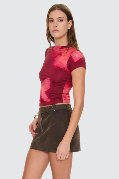 A rear-angle studio shot focusing on the upper spine and the neat topstitching along the rear crew neck collar band.