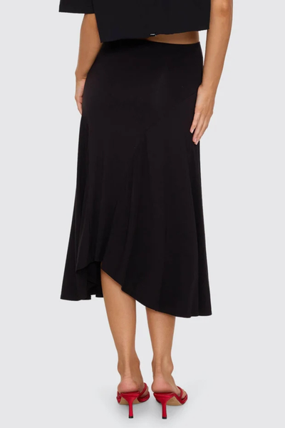 Full-length studio shot of model posing in the black Thrills Sienna Midi Skirt paired with a matching black halter bikini top.