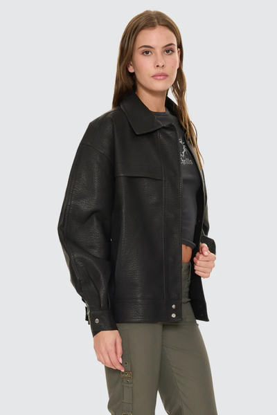 A close-up detail shot focusing on the collar and front closure of the black polyurethane jacket, showing the metal zipper teeth and the smooth inner polyester lining material where the jacket is left slightly open at the neck.