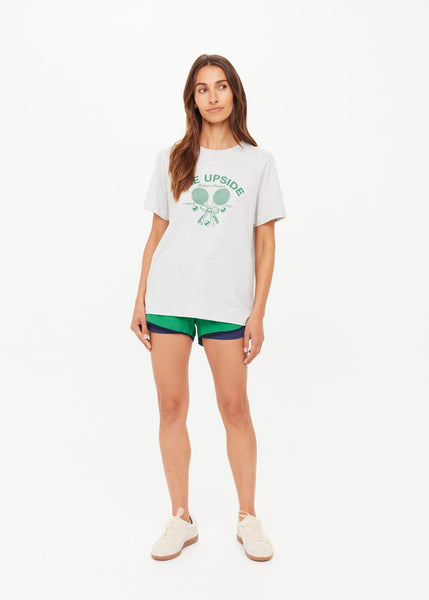 The Upside Racquet Casey Tee in grey marle. Featuring a vintage-inspired "Making a Racquet" logo in British Racing Green, this regular-fit organic cotton jersey tee offers sustainable, modern comfort.