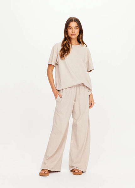 Full-body front studio view of a model wearing The Upside Soho Tokio Wide Leg Pant in Mushroom paired with a matching relaxed short-sleeve tee.