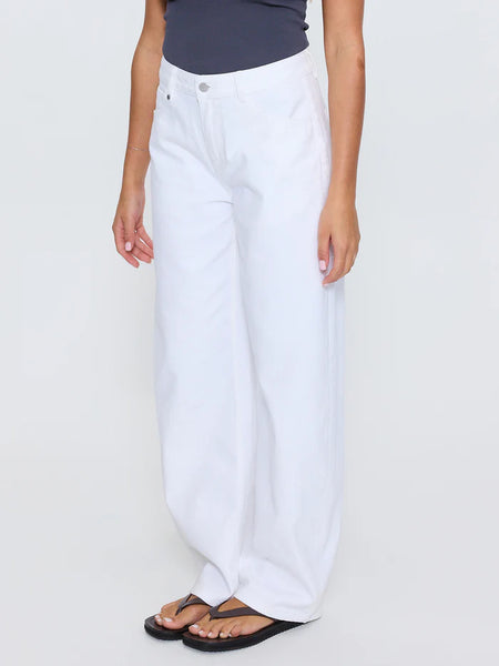 Three-quarter side angle shot focusing on the waist, hips, and relaxed barrel leg cut of the Thrills Sloane Low Rise Barrel Jeans in Whiteout.