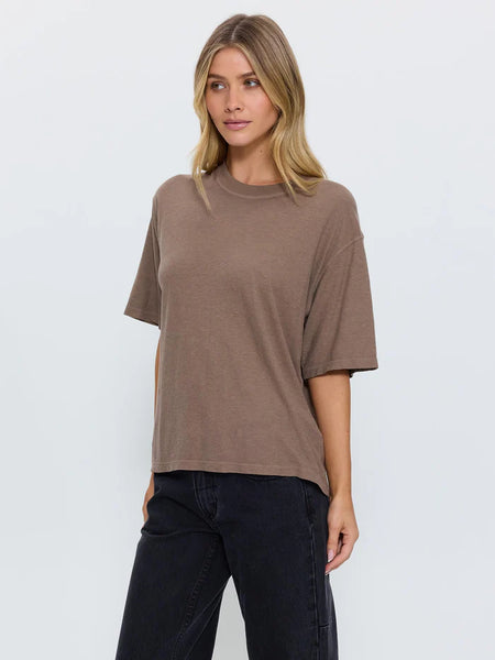 Three-quarter front studio portrait of a model wearing the Thrills Hemp Square Tee in Falcon brown, featuring the crew neckline and relaxed, slightly oversized silhouette.