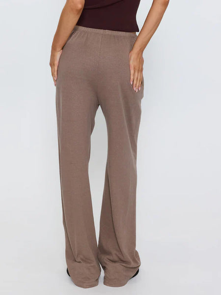 Rear view studio shot showing the back fit and straight wide-leg silhouette of the Thrills Hemp Relax Pant in Falcon brown.