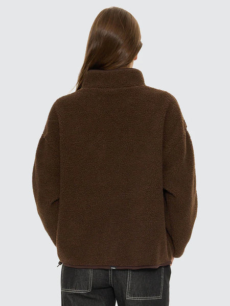 A back-profile view isolating the brown All Star Sherpa Fleece on a model to demonstrate the relaxed sleeve drape, regular fit, and the functional adjustable waist drawcord featuring a secure plastic toggle at the hemline.