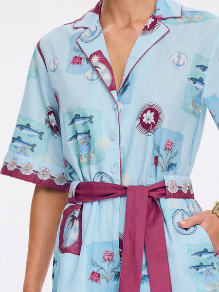 Close-up of the sleeve and bodice, focusing on the transparent eyelet details and the scalloped embroidery on the cuff.