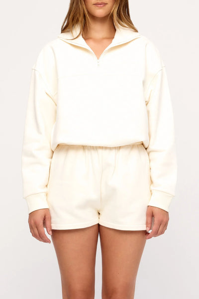 Cropped studio front view highlighting the quarter-zip collared neckline and embroidered logo of the Zulu & Zephyr Sport Sweat Shirt Fleece in Cream.