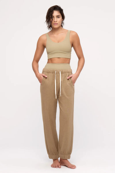 A front studio product image featuring the olive cuffed loungewear trousers, emphasizing the gathered elastic ankle cuffs and the natural drape of the soft, sustainable mid-weight organic cotton-hemp blend.