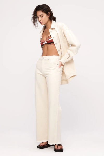 Detailed view of the raw edge hem and scooped rear hemline, showcasing the relaxed, lived-in aesthetic of the shirt jacket.