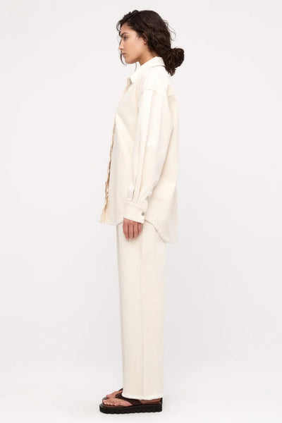 A high-quality, eco-friendly organic cotton shirt jacket in a creamy off-white Coconut tone, perfect for minimalist trans-seasonal styling.