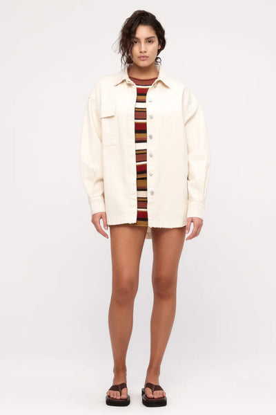 Front view focusing on the branded button closure, traditional shirt collar, and the structured yet soft drape of the denim fabric.