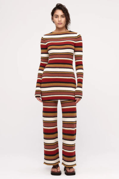 A long-sleeve bouclé knit mini dress featuring a multi-stripe "Earth" pattern in red, brown, mustard yellow, cream, and black.