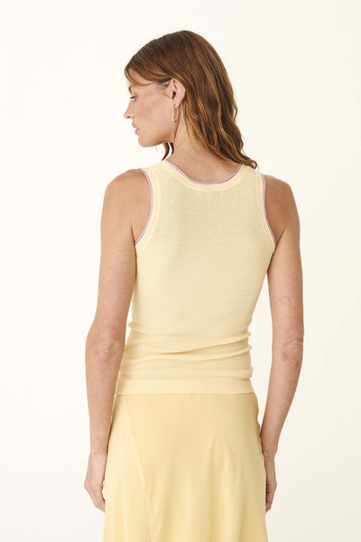 Studio rear view of a model wearing the lemon knit tank, highlighting the fitted silhouette and contrast trim along the back neckline and armholes.