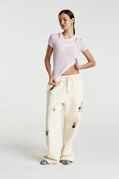A full-length view of the trackpants, illustrating the effortless "off-duty" silhouette and the clean, minimalist look of the Vanilla hue.